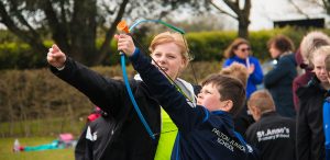 female archery coach coaching
