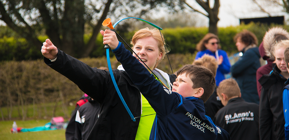 Female archery coach coaching 