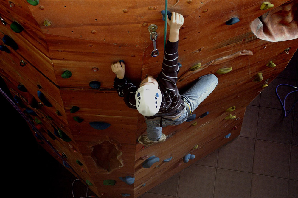 A boy climbing on a climbing walk 