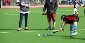 Boy hitting a hockey ball