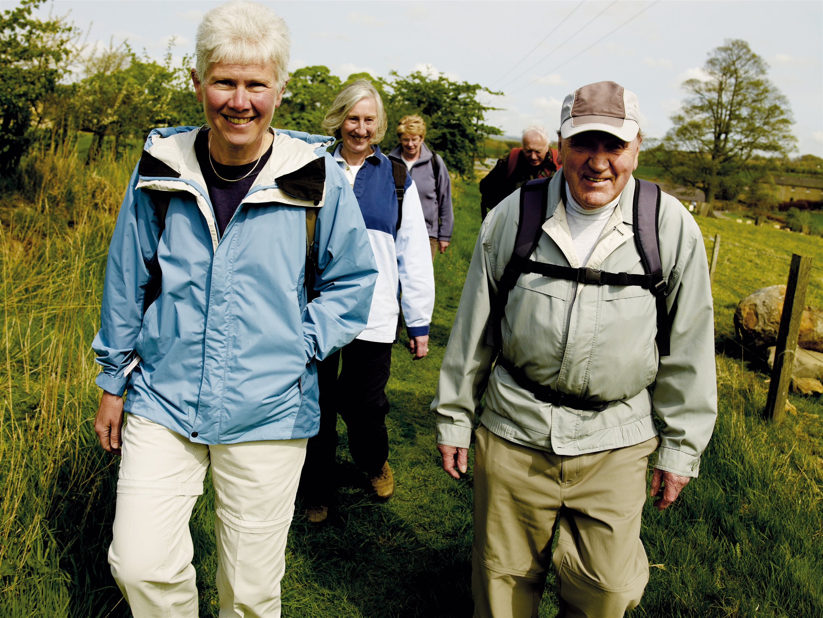 A group of people walking in the country side