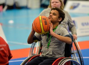 boy playing wheelchair basketball