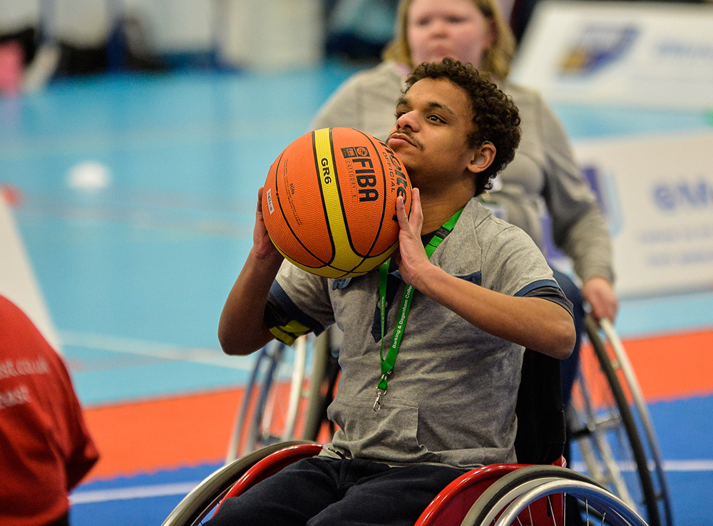 boy playing wheelchair basketball 