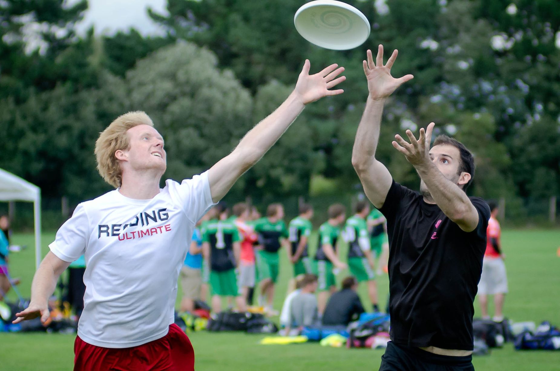 Two mean contesting for the frisbee 