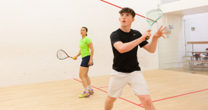 Two people playing squash